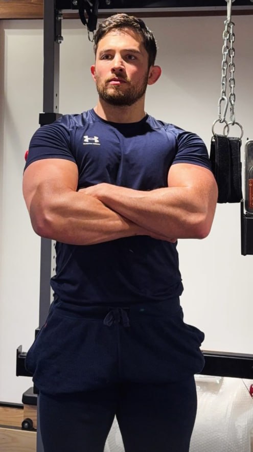 Ed standing in the gym with arms folded